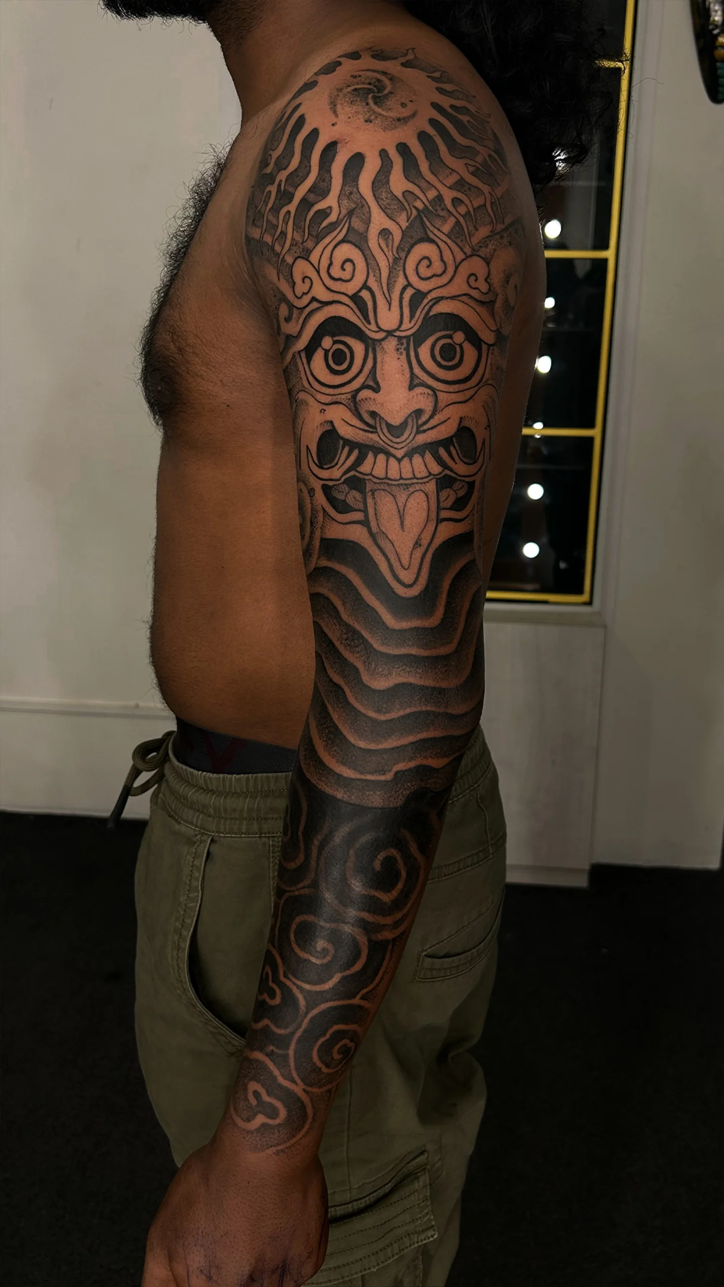 Black and grey portrait tattoo with soft linework and expressive depth by Eric Edward