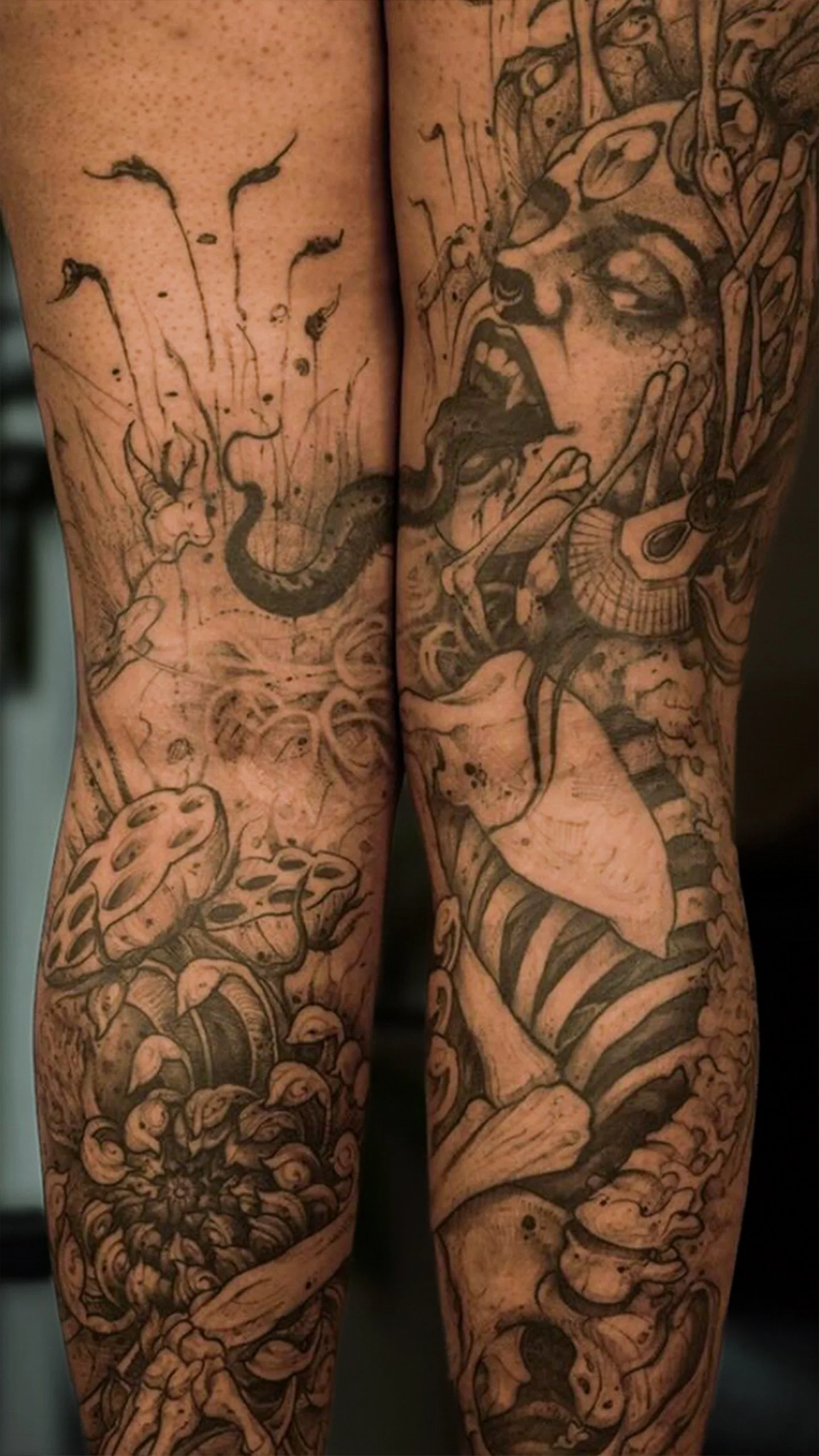 Semi-realistic black and grey tattoo with symbolic motifs by Eric Edward