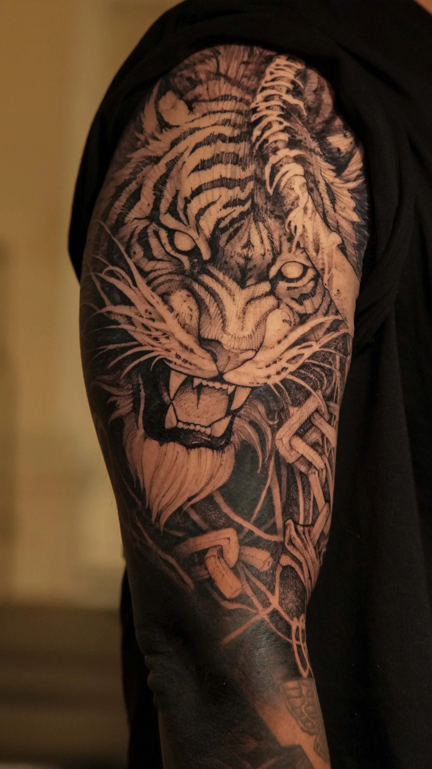 Detailed black and grey tattoo with atmospheric tone and subtle textural emphasis by Otzi Marc